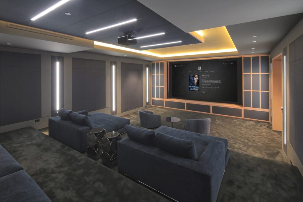 Control4 Custom Home Cinema with seating, speakers, and projector.